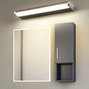 Bathroom setup with a mirror and cabinet under a wall-mounted light fixture.