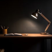 Dark room with a desk, lamp, and chair.